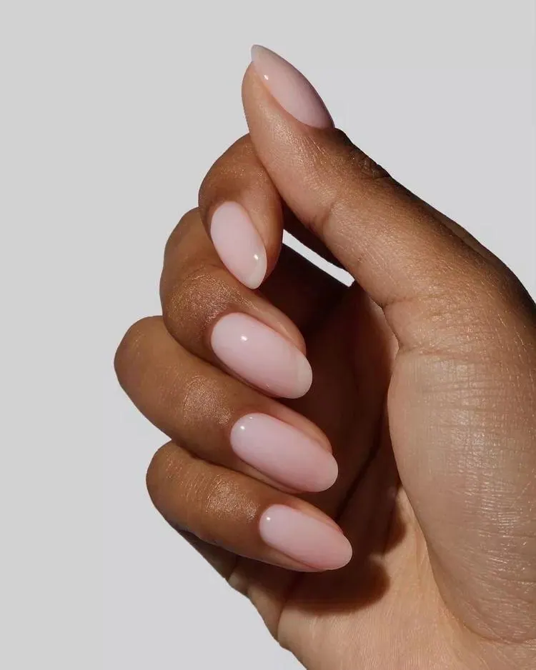Glossy almond-shaped pale pink manicure